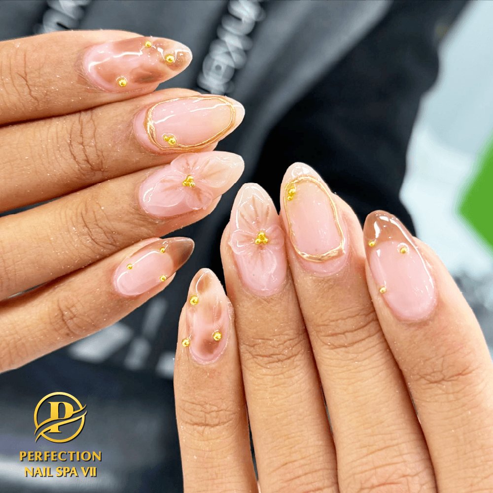 Pink almond nails with gold floral art